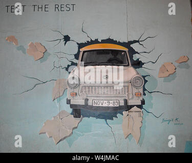 BERLIN - 18 APRIL 2019: Trabi, painted outside by artist Birgit Kinder on a stretch of the Berlin Wall. Stock Photo