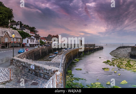 Lynmouth Harbour, North Devon, England. Tuesday 23rd July 2019. UK Weather. At dusk the streetlights flicker on in the picturesque little harbour of L Stock Photo