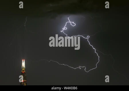 London, UK. 24th July, 2019. UK Weather: Dramatic lightning strikes over The Shard skyscraper building in the early hours of Wednesday. Credit: Guy Corbishley/Alamy Live News