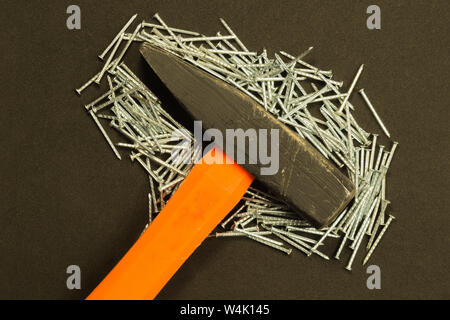 Hammer with metal nails isolated on black background Stock Photo