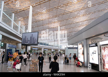 Beijing, China - June 17, 2019: People walking at international departures terminal at the airport Stock Photo