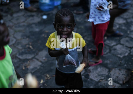 Tapachula, Chiapas, Mexico. 23rd July, 2019. Children from Haitian and African families push to each other on Tuesday, trying to reach a piece of bread and pampers given by catholic nuns of Mision Cristo Resusitado from Guadalajara Mexico, just steps away from Siglo XXI immigration center in Tapachiula, where most wait three to four months for a permit to travel north to the US-Mexico border. Credit: Miguel Juarez Lugo/ZUMA Wire/Alamy Live News