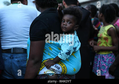 Tapachula, Chiapas, Mexico. 23rd July, 2019. Haitian and African families push to each other on Tuesday, trying to reach a piece of bread and pampers given by catholic nuns of Mision Cristo Resusitado from Guadalajara Mexico, just steps away from Siglo XXI immigration center where most waits three to four months for a permit to travel north to the US-Mexico border. Credit: Miguel Juarez Lugo/ZUMA Wire/Alamy Live News