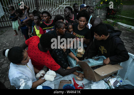 Tapachula, Chiapas, Mexico. 23rd July, 2019. Haitian and African families push to each other on Tuesday, trying to reach a piece of bread and pampers given by catholic nuns of Mision Cristo Resusitado from Guadalajara Mexico, just steps away from Siglo XXI immigration center where most waits three to four months for a permit to travel north to the US-Mexico border. Credit: Miguel Juarez Lugo/ZUMA Wire/Alamy Live News