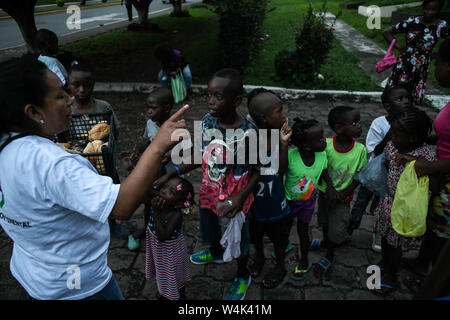 Tapachula, Chiapas, Mexico. 23rd July, 2019. Children from Haitian and African families push to each other on Tuesday, trying to reach a piece of bread and pampers given by catholic nuns of Mision Cristo Resusitado from Guadalajara Mexico, just steps away from Siglo XXI immigration center where most wait three to four months for a permit to travel north to the US-Mexico border. Credit: Miguel Juarez Lugo/ZUMA Wire/Alamy Live News