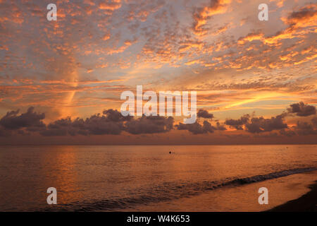 Beautiful cloud coastline abstract background. Fiery orange sunset sky. Amazing sunrise on the beach in Bali Indonesia. Fantastic landscape. Stock Photo