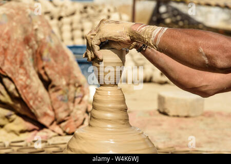 Indian potter making clay pots on pottery wheel in Bikaner. Rajasthan, india Stock Photo