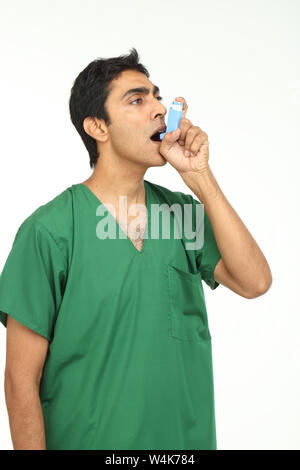 Patient using asthma inhaler Stock Photo