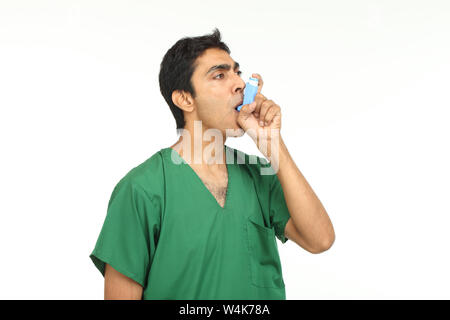 Patient using asthma inhaler Stock Photo