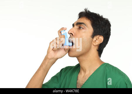 Patient using asthma inhaler Stock Photo
