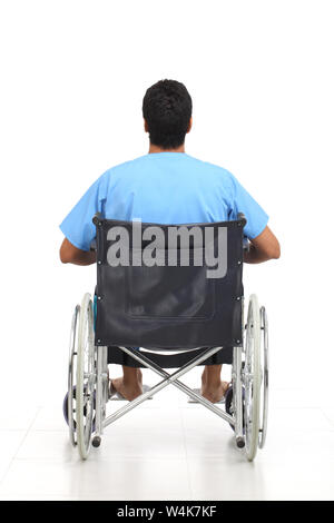 Rear view of a patient sitting in a wheelchair Stock Photo