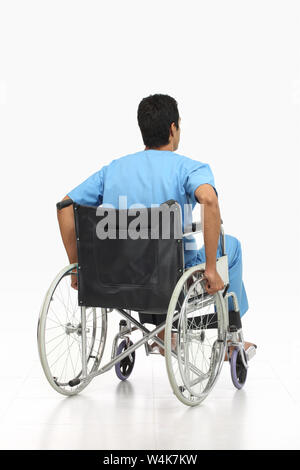 Rear view of a patient sitting in a wheelchair Stock Photo