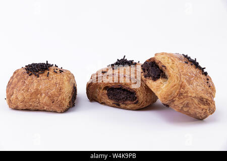 Three tasty puff pastry rolls filled with freshly baked chocolate isolated on a white background Stock Photo