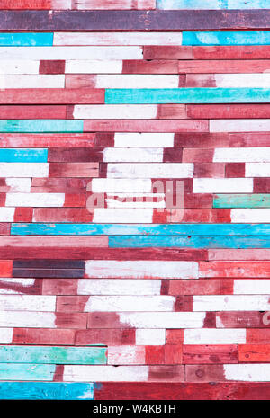 Wall background of old aged weather-beaten boards painted in bright colors. The art of drawing a background decoration. Stock Photo