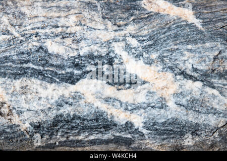 The background is a natural plate made of white with blue, yellow and purple veins of Karar marble Stock Photo