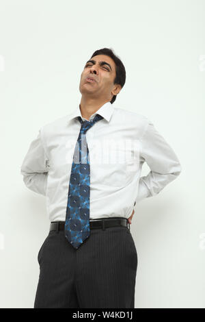 Businessman suffering from lower back pain Stock Photo