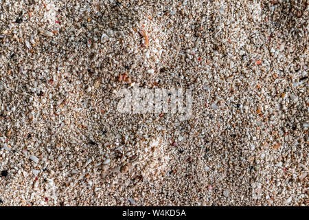 Textured and Abstract Background, consisting of Natural patterns formed off finely eroded beach pebbles/gravels, at coastal region of a remote island. Stock Photo