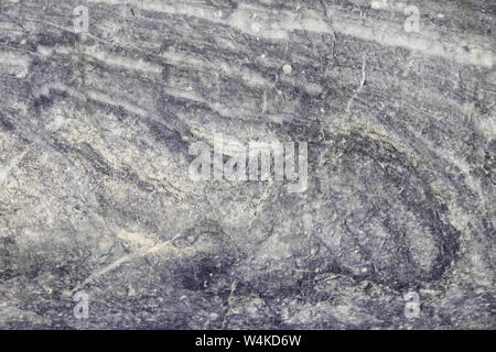 The background is a natural plate made of gray violet carar marble/ Macro. Stock Photo