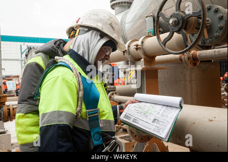 Tobolsk, Russia - May 29. 2018: Sibur company. Construction of plant on processing of hydrocarbons. Construction worker on a construction site checks Stock Photo