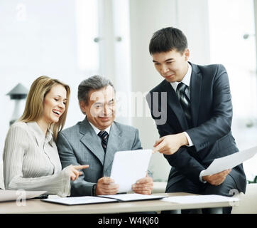 A successful business group discusses a work plan using in the tablet Stock Photo