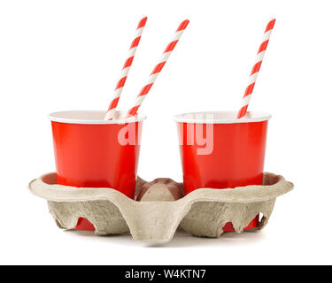 Red disposable paper cups with a cup carrier and straws. Isolated on a white. Stock Photo