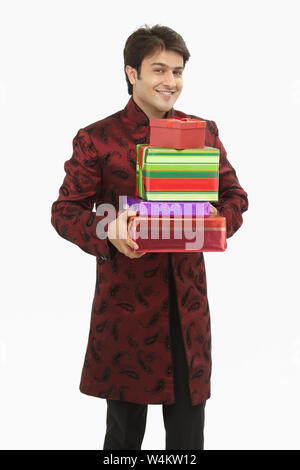 Indian bride holding gift boxes and smiling Stock Photo