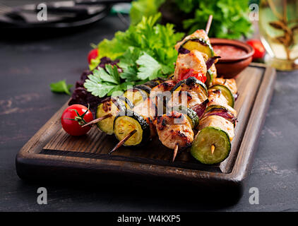 Grilled meat skewers, chicken  shish kebab with zucchini, tomatoes and red onions. Barbecue food. Stock Photo