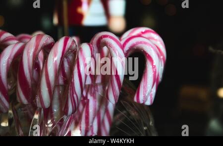 Close-up of red and white striped candy canes on display in a glass jar Stock Photo