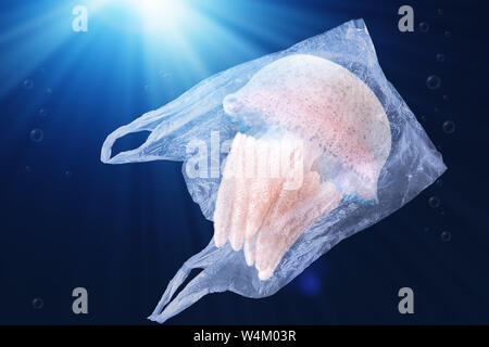 plastic pollution in ocean environmental problem concept.  jellyfish swim inside plastic bag floating in the ocean Stock Photo
