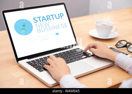 business people working on notebook laptop computer with startup business and rocket logo on screen, start up ideas business development Stock Photo