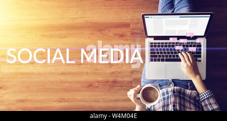 people using internet via notebook computer laptop for social media interactions with notification icons from friend in social network with like, mess Stock Photo