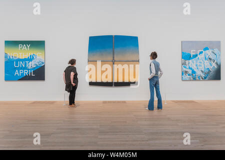 London, UK. 24th July, 2019. Pay Nothing Until April, 2003, Charles Atlas Landscape, 2003, and DAILY PLANET 2003 - ARTIST ROOMS: Ed Ruscha at Tate Modern. The latest in the series of annual free displays in the dedicated ARTIST ROOMS gallery in Tate Modern’s Blavatnik building. It opens to the public on 26 July 2019 and will run until Spring 2020. Credit: Guy Bell/Alamy Live News Stock Photo