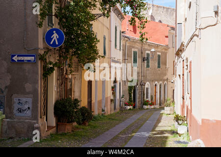 Scenics sidewalk street between two row of houses and a tattoo shop in Alghero, Sardinia Stock Photo