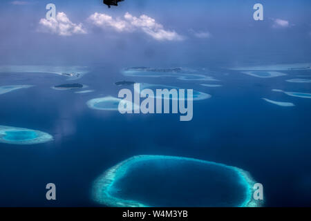 This unique image shows the Maldives photographed from a plane from above. You can see the atolls in the sea well. Stock Photo