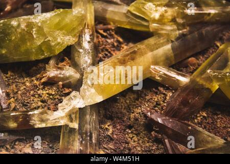 Yellow and brown quartz crystal shards embedded in mineral rock Stock Photo