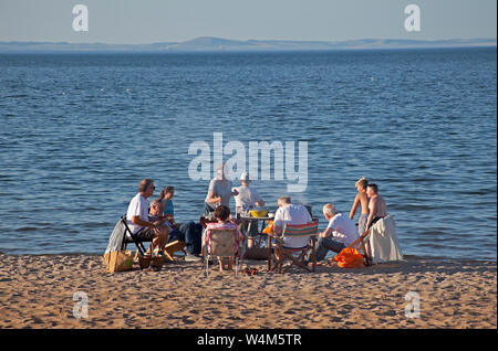 Family having barbeque on Portobello Beach, Edinburgh, Scotland, UK Stock Photo