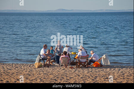 Family having barbeque on Portobello Beach, Edinburgh, Scotland, UK Stock Photo