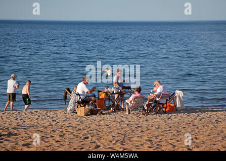 Family having barbeque on Portobello Beach, Edinburgh, Scotland, UK Stock Photo