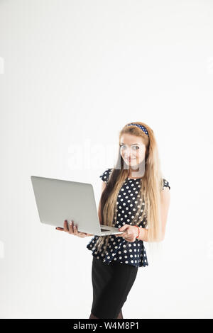 confident female administrator with an open laptop on a white background. the photo has a empty space for your text Stock Photo