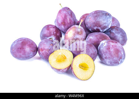 Purple plums on a white background. Ripe fruit. Stock Photo