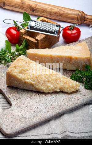 Cheese collection, Italian original aged Parmesan cheese in two pieces close up Stock Photo