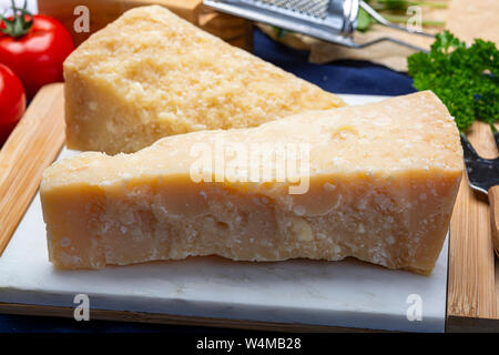 Cheese collection, Italian original aged Parmesan cheese in two pieces close up Stock Photo
