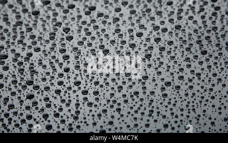 Raindrops on the black surface Stock Photo