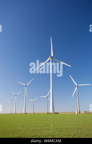 Wind turbines in Holland producing clean and sustainable energy to help against global warming Stock Photo