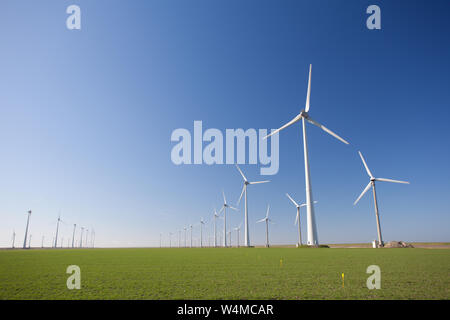 Wind turbines in Holland producing clean and sustainable energy to help against global warming Stock Photo