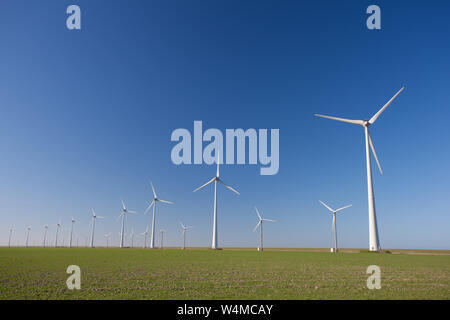 Wind turbines in Holland producing clean and sustainable energy to help against global warming Stock Photo