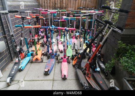 Lots of Scooters parked outside a school Stock Photo