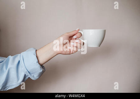 Close-up of a woman holding a cup of black coffee