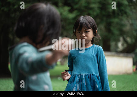 two little girls fighting over toys Stock Photo