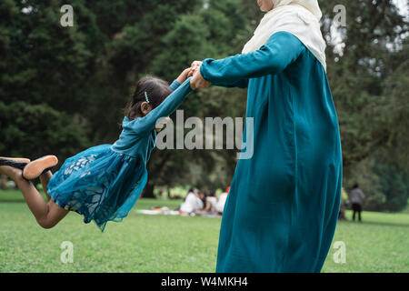 Mother holding her daughter and spin around happily Stock Photo